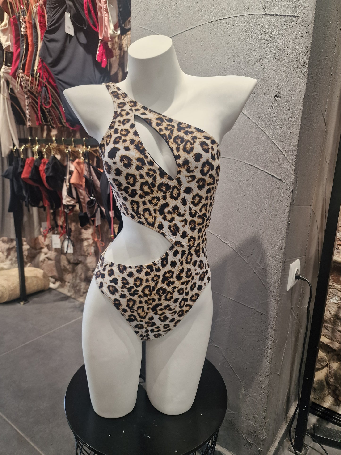 Leopard print mask on a mannequin head with a fashion store background