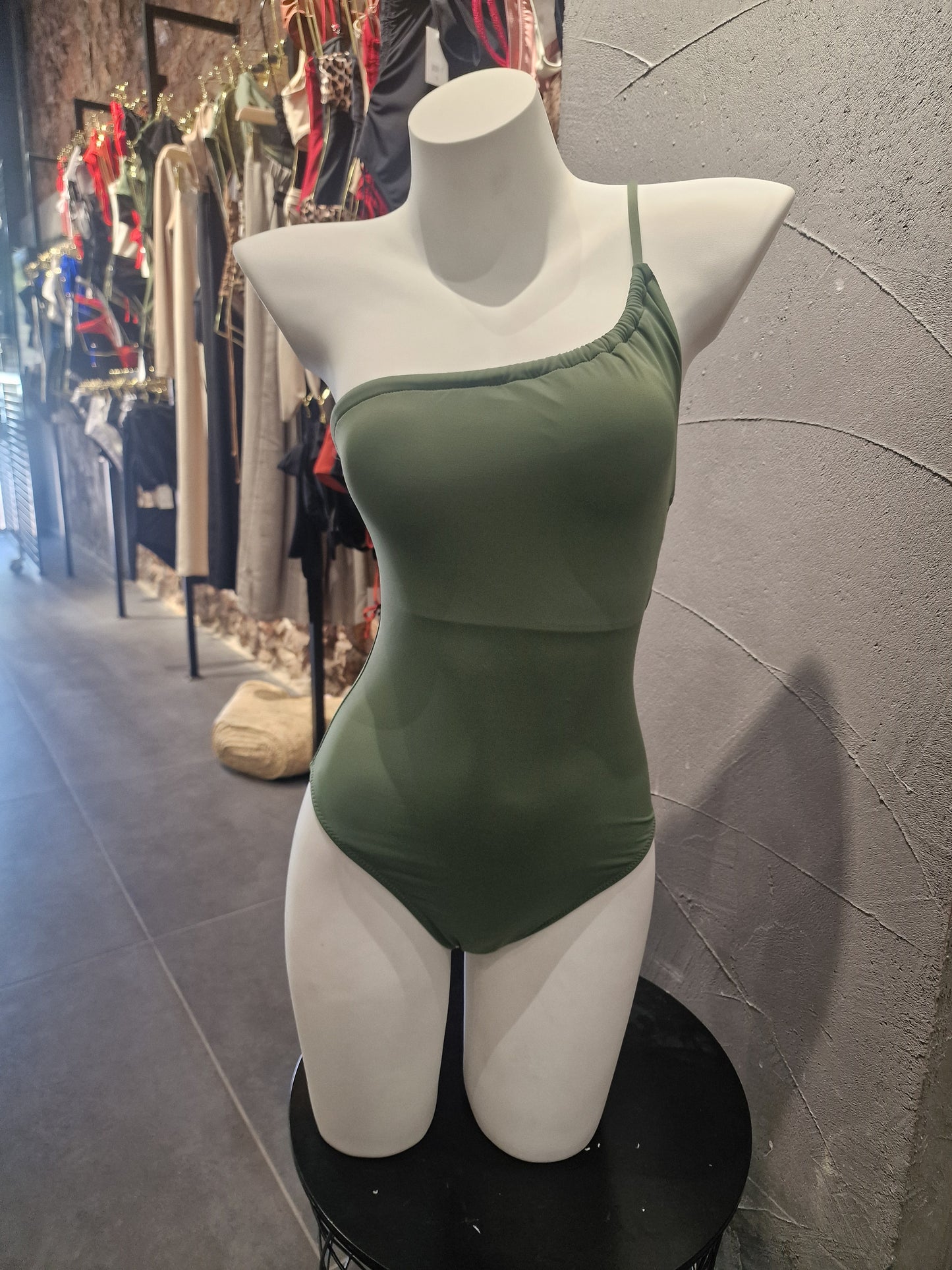 Green dress on a mannequin with a blurred background