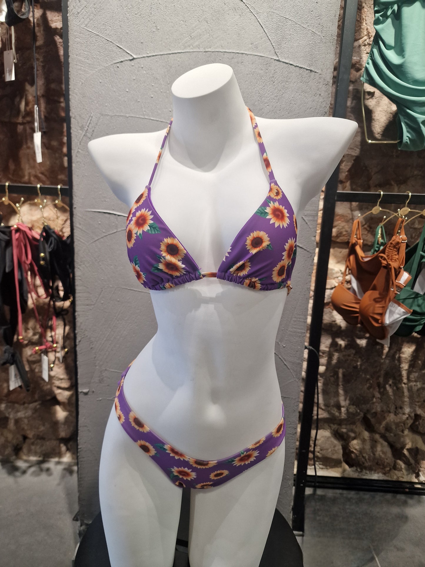 Bikini set on a mannequin in a store setting with floral pattern