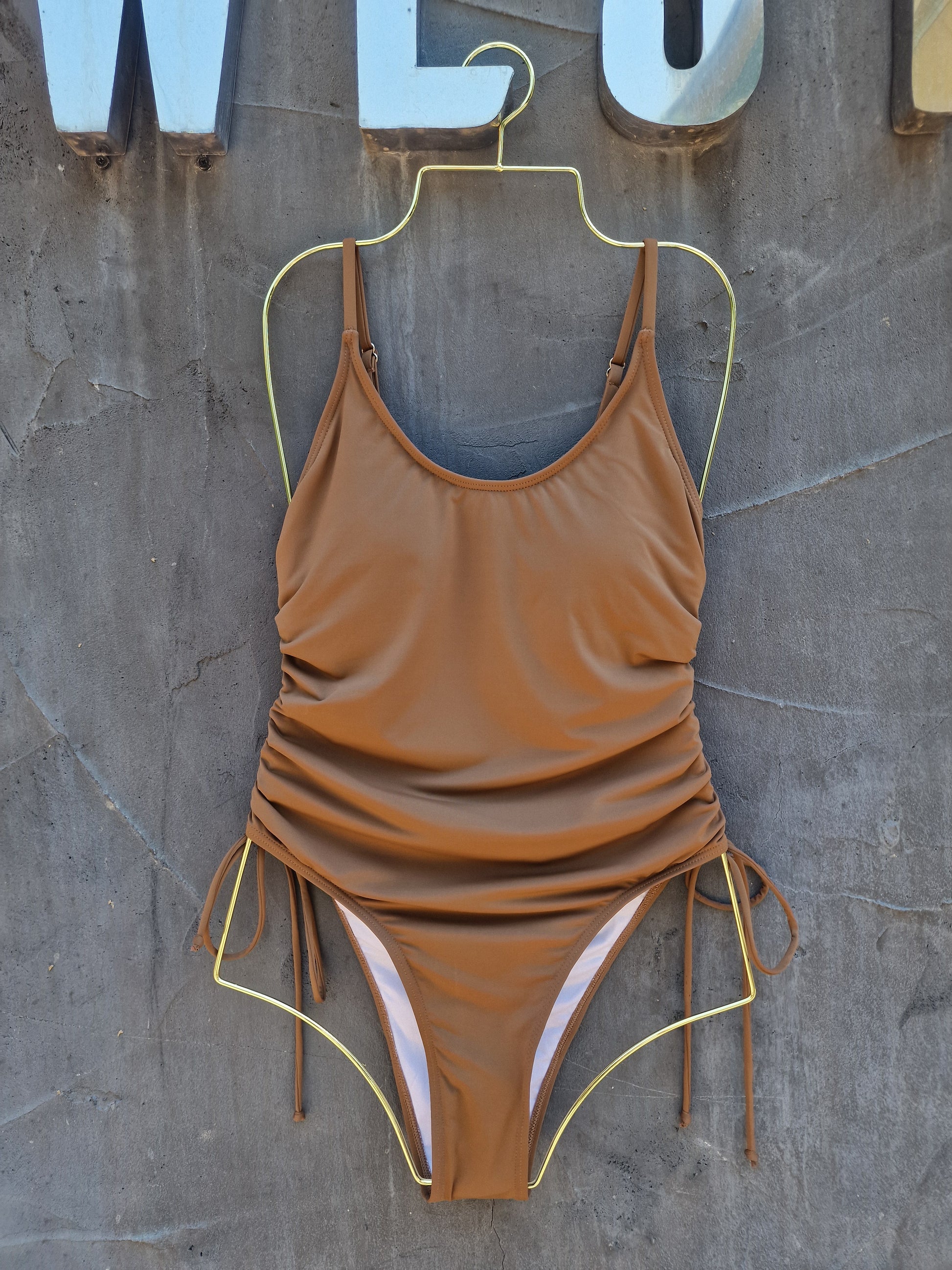 Brown swimsuit on a textured surface