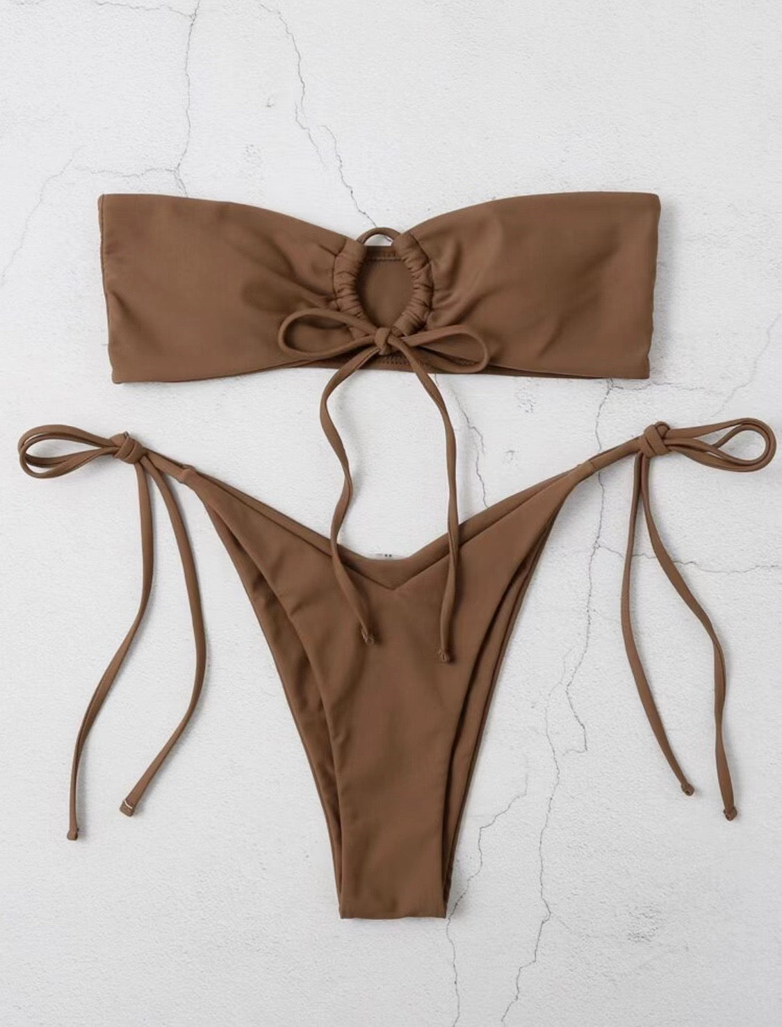 Brown bikini set on a light gray background
