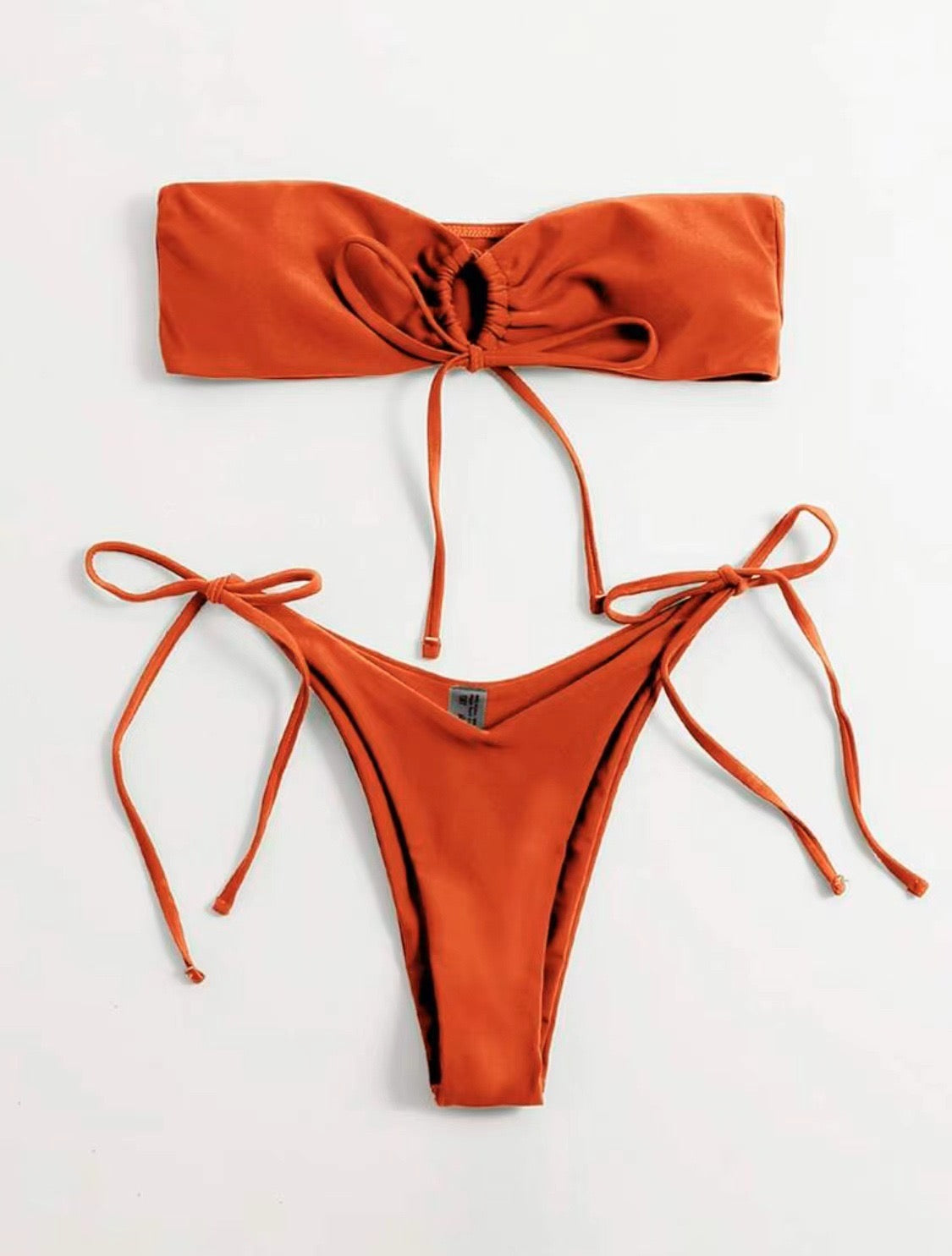 Orange bikini set on a light gray background