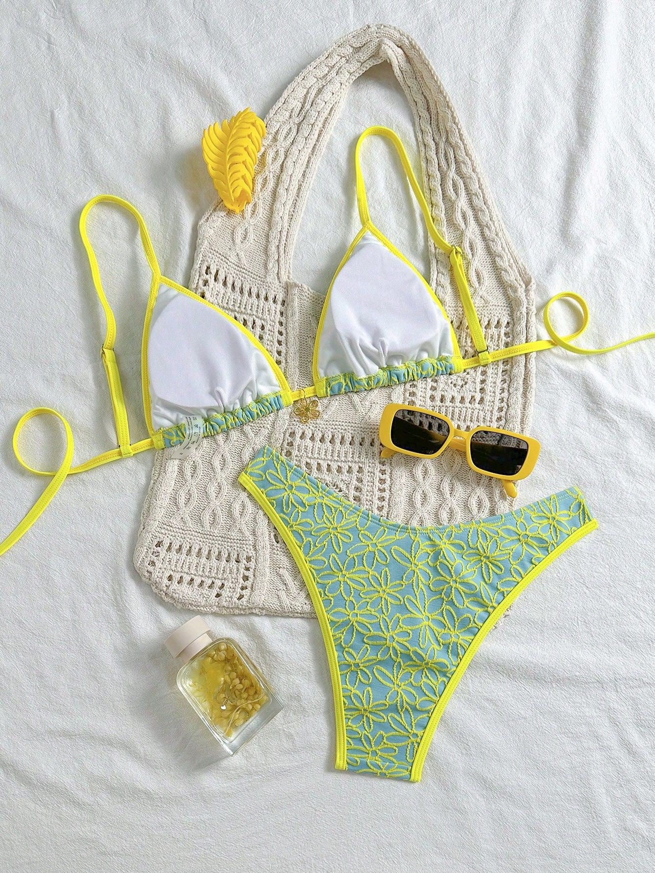 Crocheted bikini set with yellow and green details on a white background