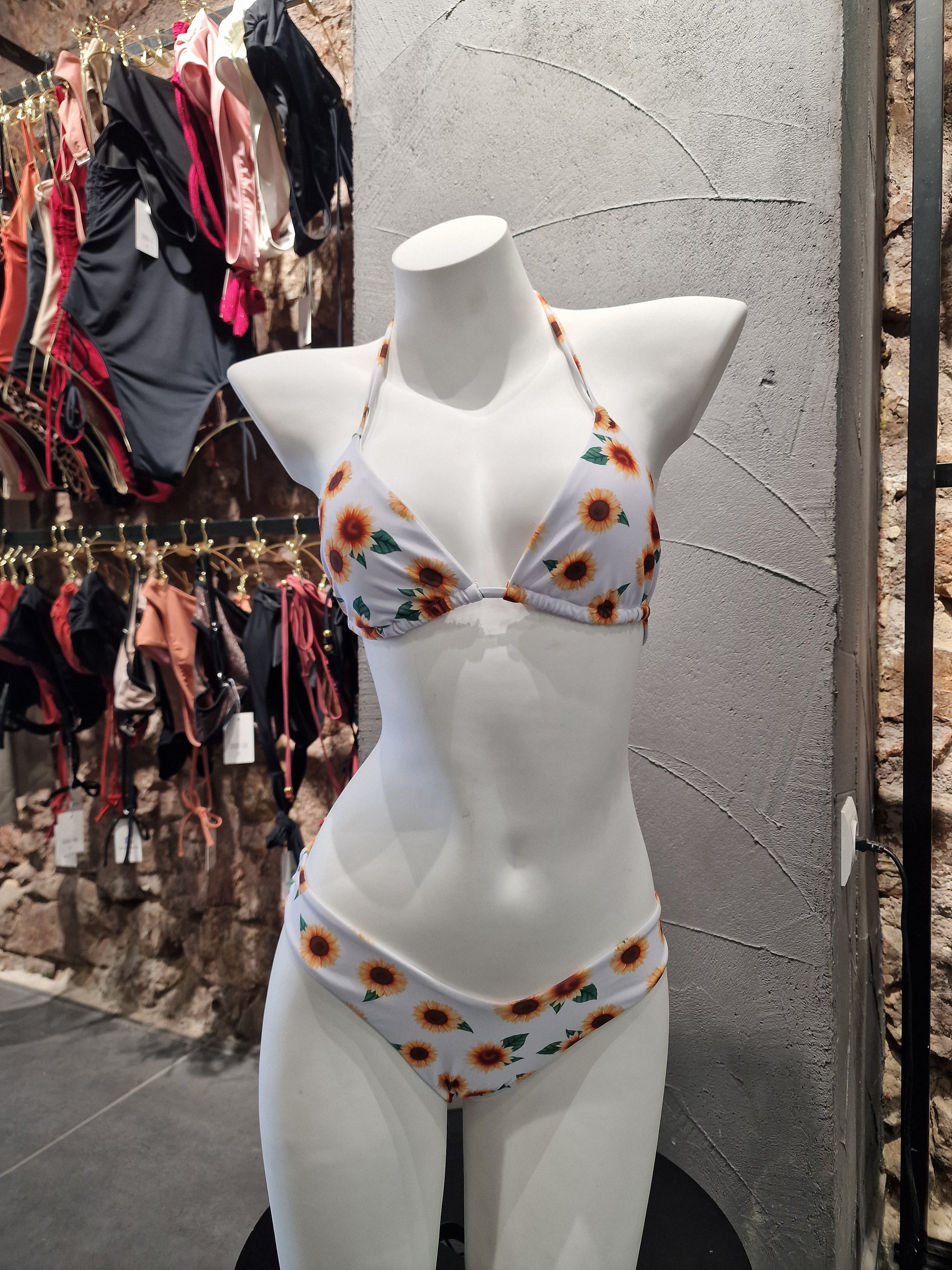 Mannequin wearing a floral bikini top with a blurred background