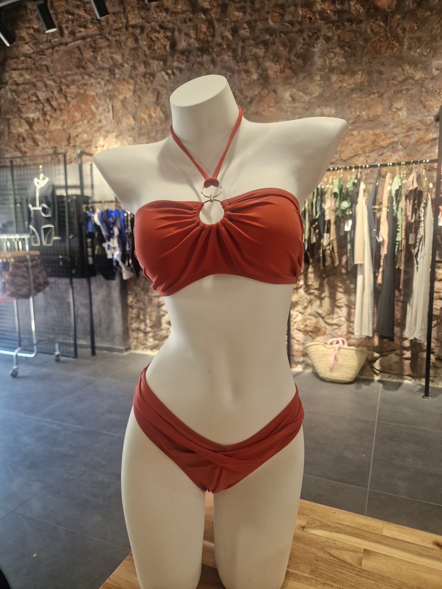 Red bikini on a mannequin against a reflective surface

