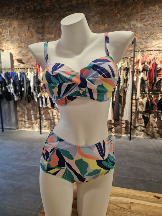Colorful swimsuit on a mannequin against a blurred store background
