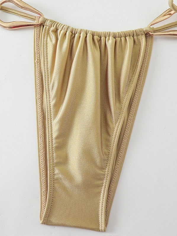 Beige women's underwear on a hanger against a white background

