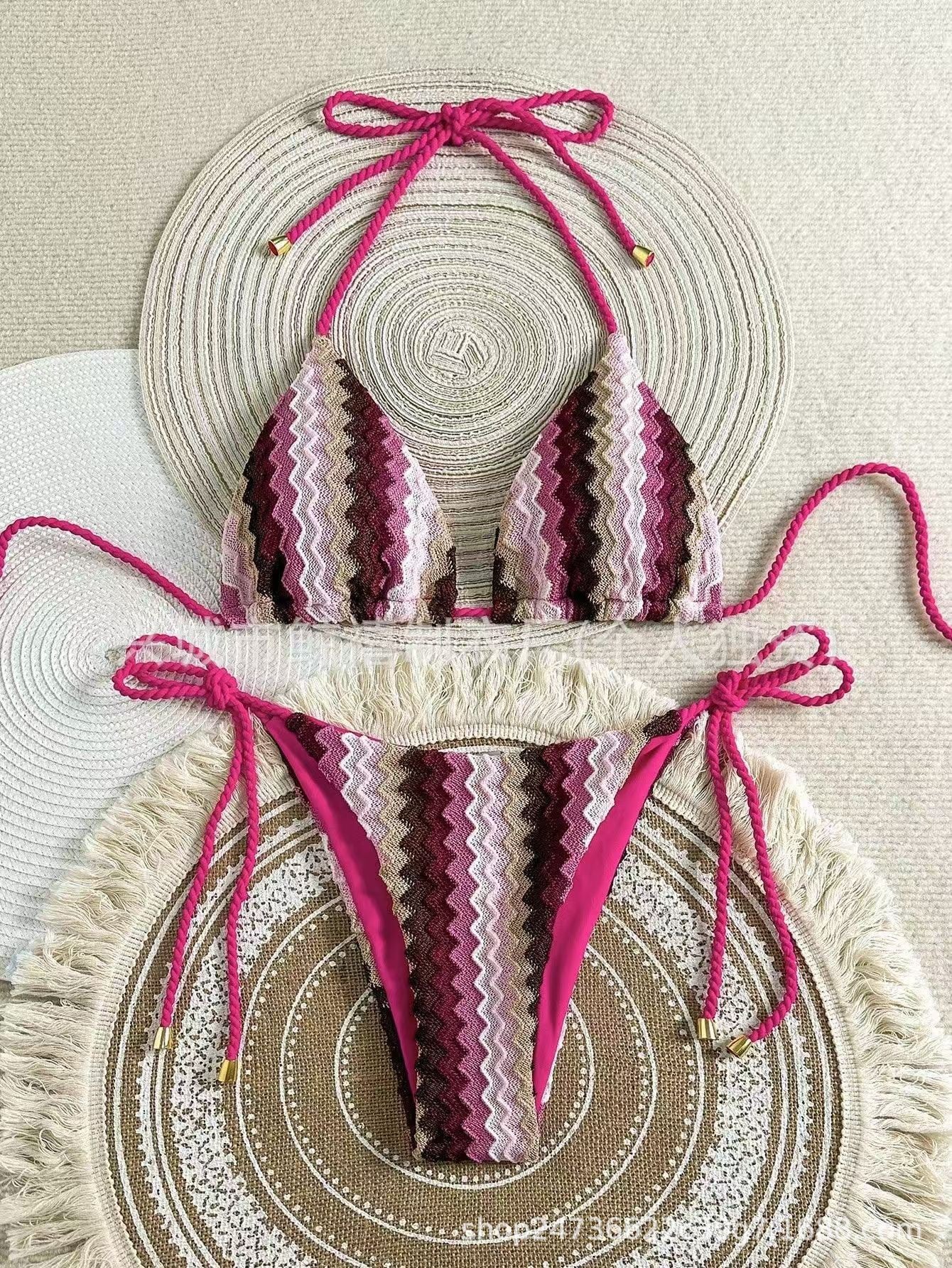 Bikini set with pink and purple pattern on a textured surface

