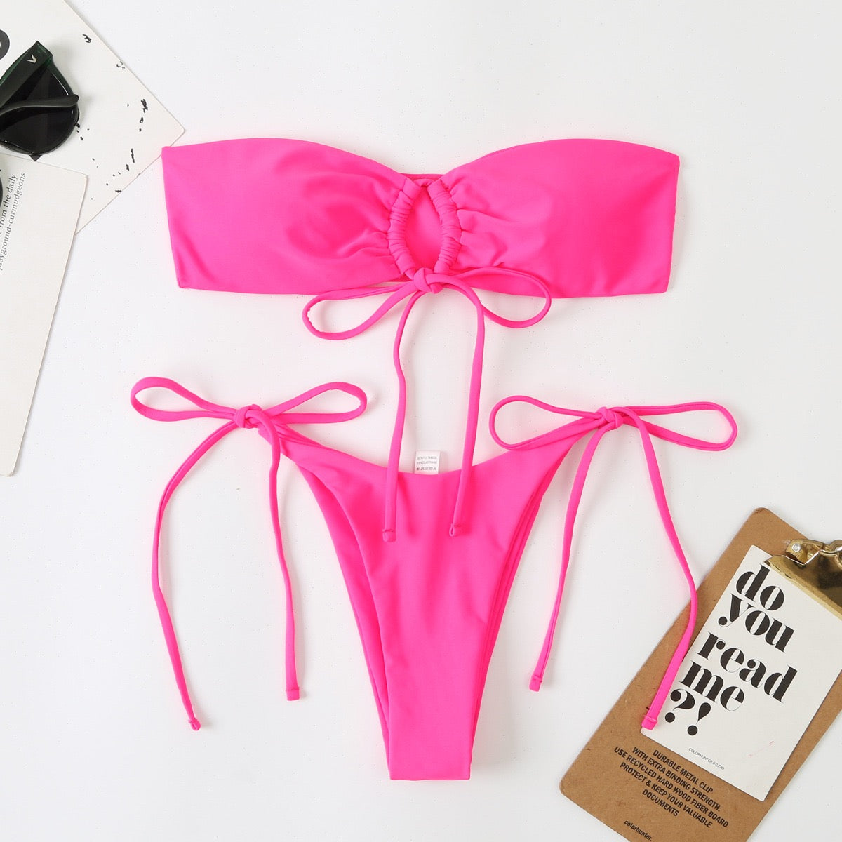Hot pink bikini set on a white background with a tag reading 'do you read me?'.

