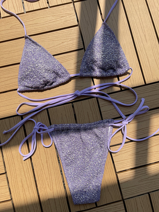 Purple glitter bikini set on a wooden deck

