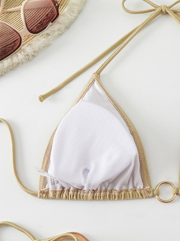 White bikini top with gold trim on a white background

