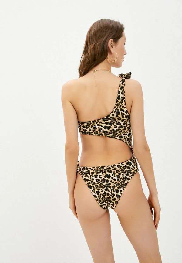 Woman wearing a leopard print bikini on a white background

