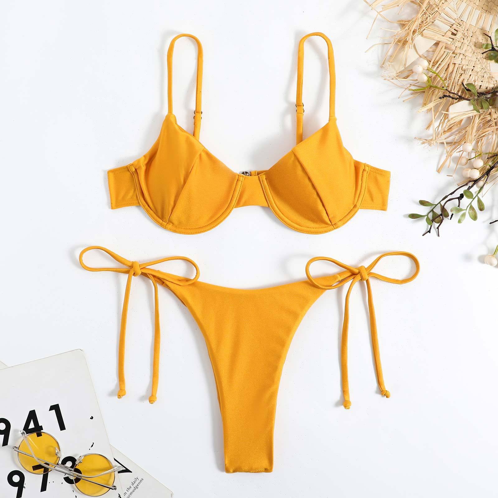 Yellow bikini set on a white background with decorative elements.

